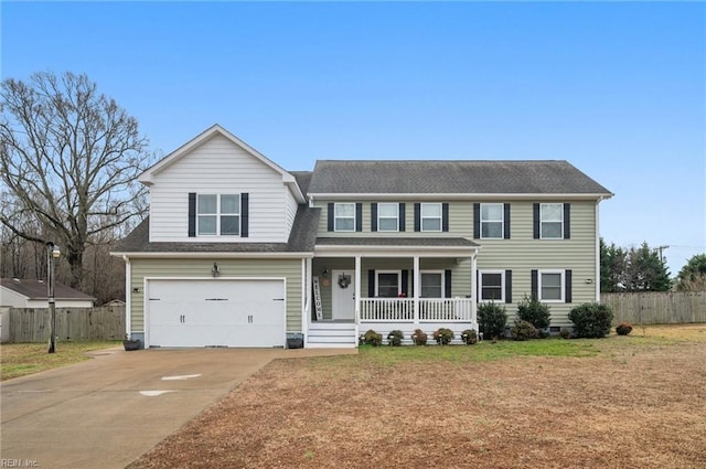 view of front facade with a garage, a front yard, and a porch