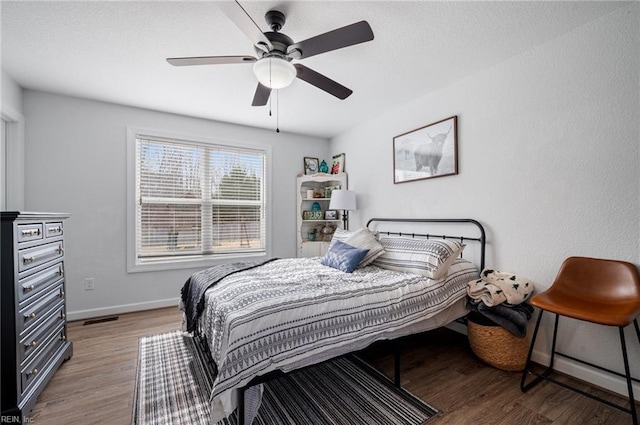 bedroom with ceiling fan and hardwood / wood-style floors