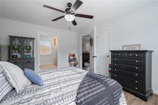 bedroom with ceiling fan and light hardwood / wood-style floors