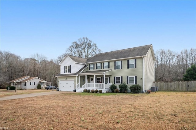 view of front of home with a porch, central AC, a garage, and a front yard