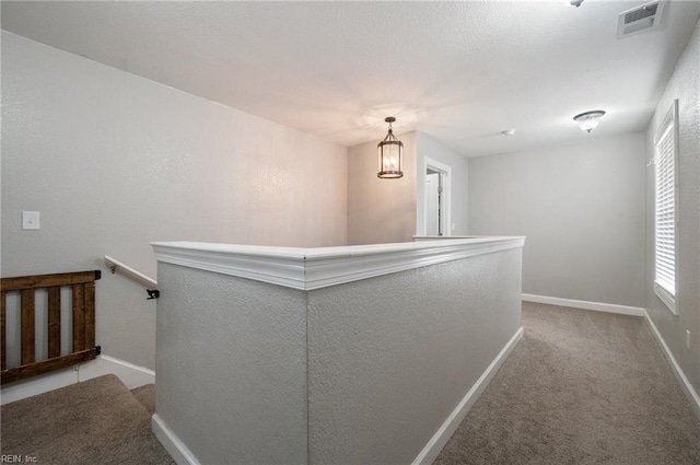 hallway featuring carpet flooring