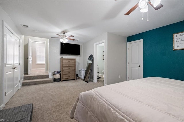 carpeted bedroom with ceiling fan and ensuite bathroom