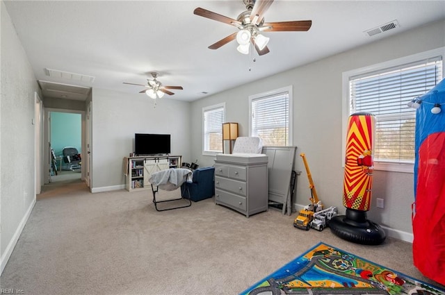 playroom featuring light colored carpet and ceiling fan