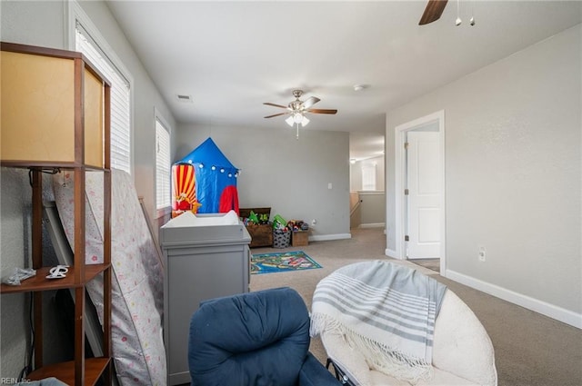 interior space with ceiling fan and light carpet