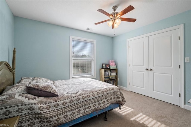 carpeted bedroom with a closet and ceiling fan