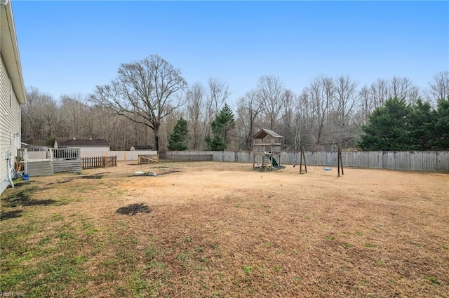 view of yard featuring a playground and a storage unit