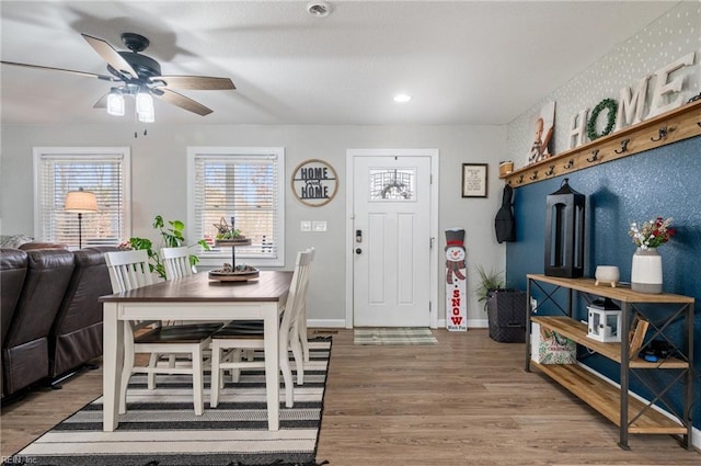 dining area with hardwood / wood-style floors and ceiling fan