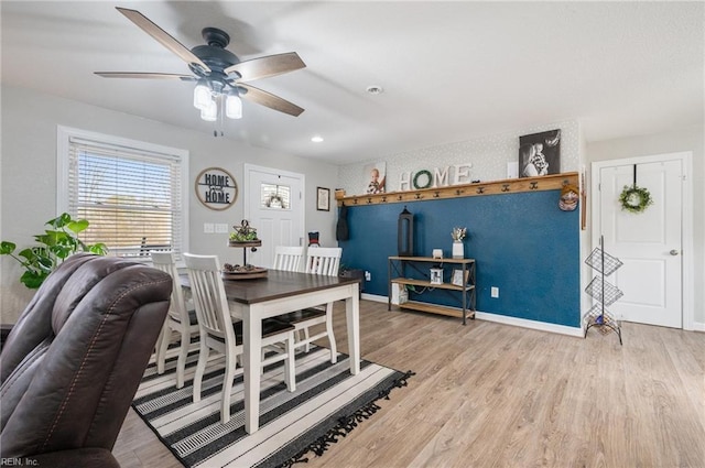 dining room featuring wood-type flooring and ceiling fan