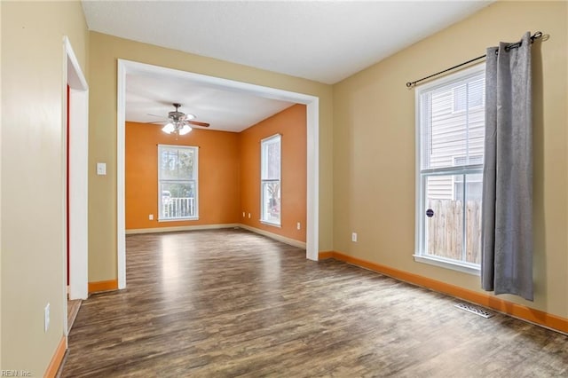 unfurnished room featuring dark wood-type flooring and ceiling fan