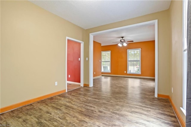 empty room with hardwood / wood-style flooring and ceiling fan