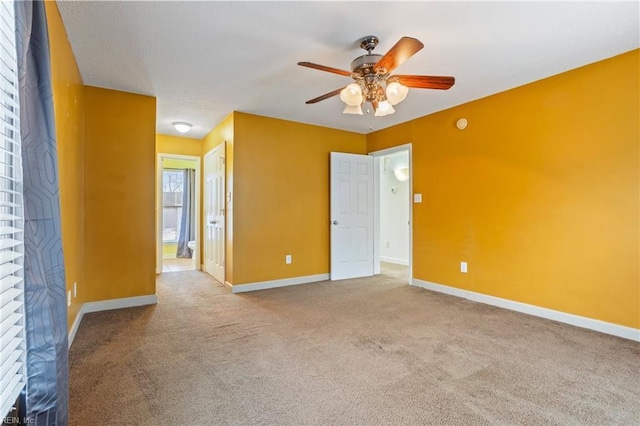 empty room with ceiling fan and carpet flooring