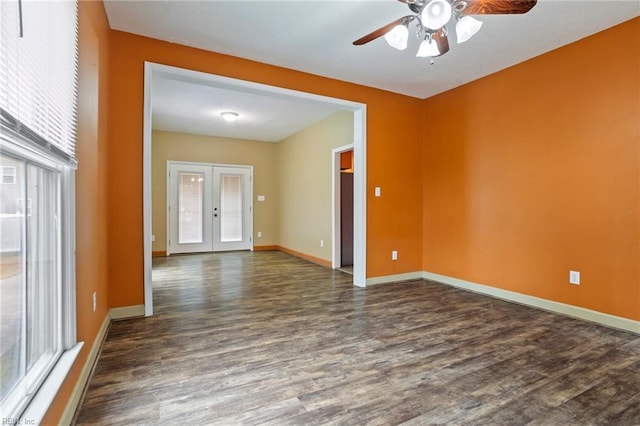 empty room featuring dark hardwood / wood-style floors, french doors, and ceiling fan