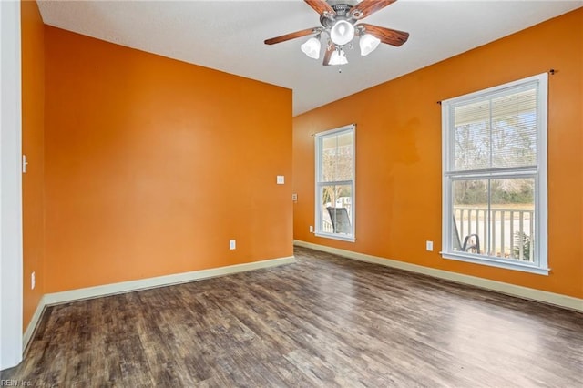 empty room with hardwood / wood-style flooring, ceiling fan, and a wealth of natural light