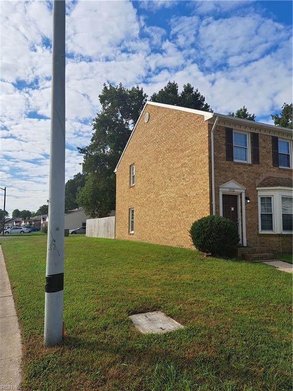 view of side of home with a lawn