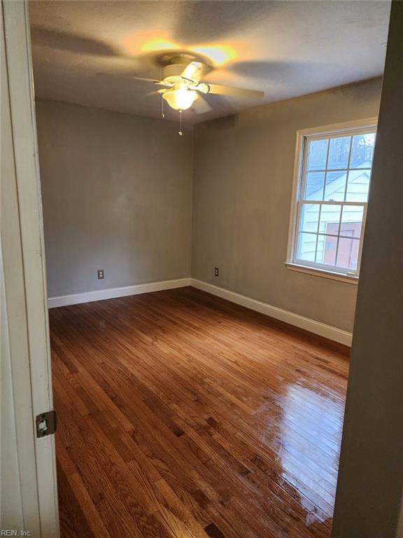 spare room with hardwood / wood-style flooring and ceiling fan