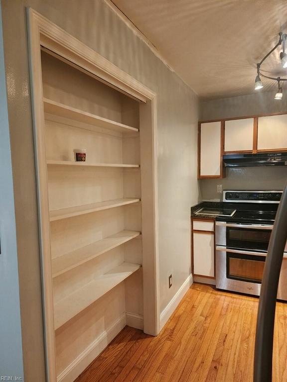 kitchen featuring double oven range and light hardwood / wood-style flooring