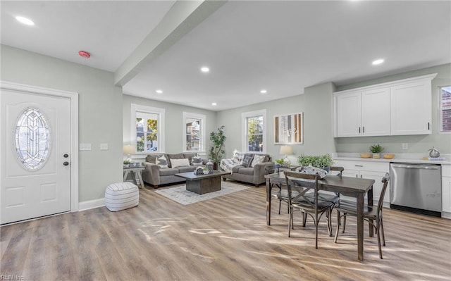 dining area with light hardwood / wood-style flooring and a healthy amount of sunlight