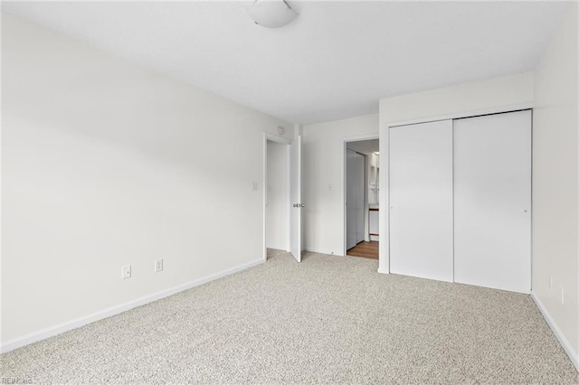 unfurnished bedroom with carpet floors and a closet