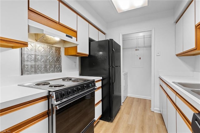 kitchen with white cabinetry, light wood-type flooring, and black appliances