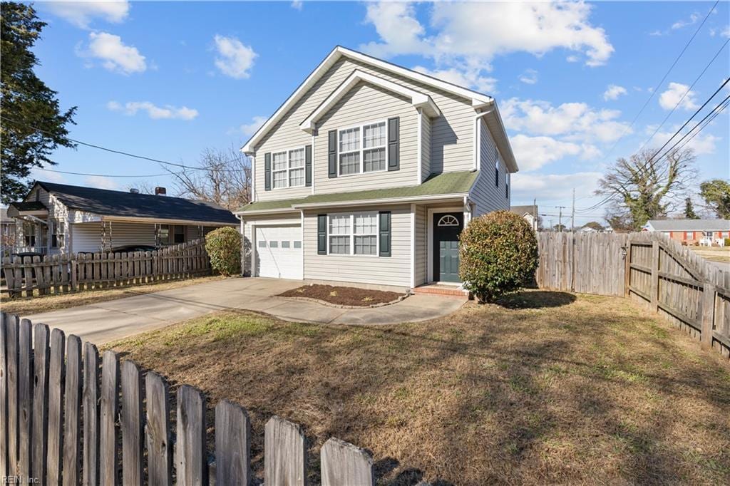 view of front of house with a garage and a front lawn