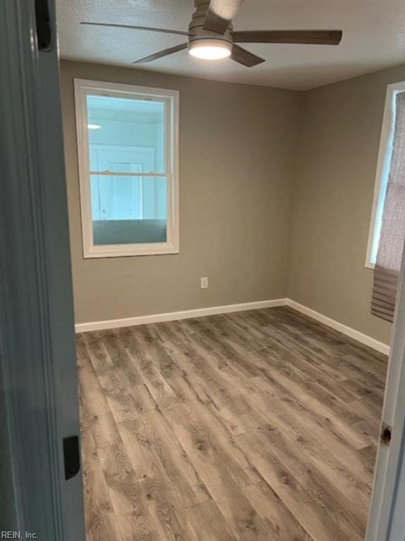 empty room featuring hardwood / wood-style flooring and ceiling fan