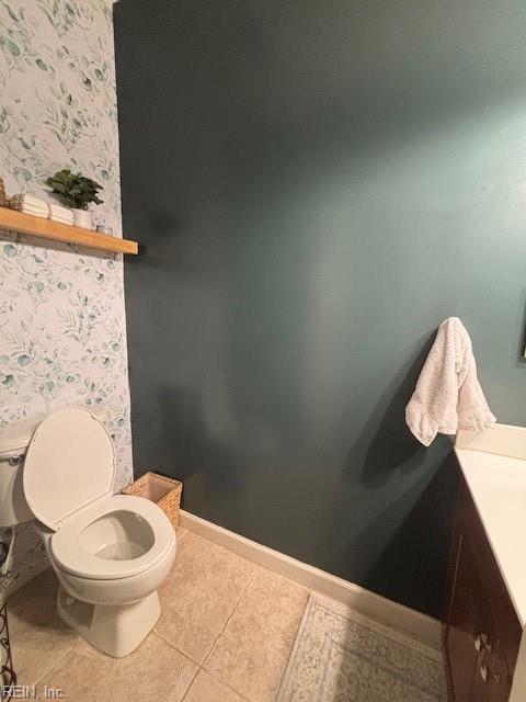 bathroom featuring vanity, tile patterned floors, and toilet