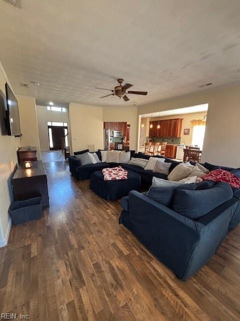 living room with ceiling fan and dark hardwood / wood-style floors