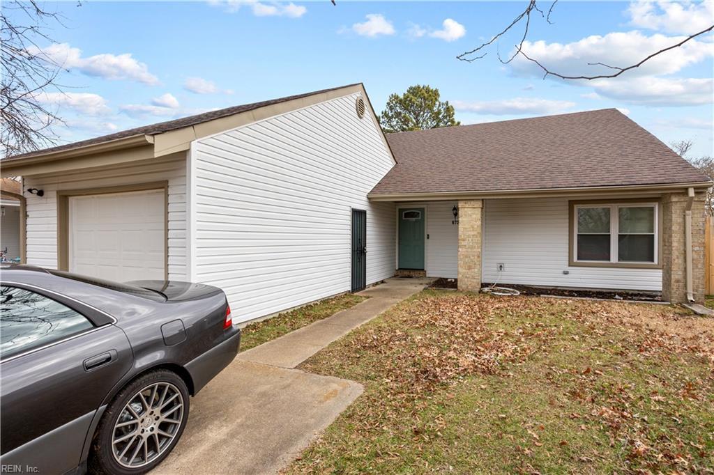 single story home with a garage and a front yard