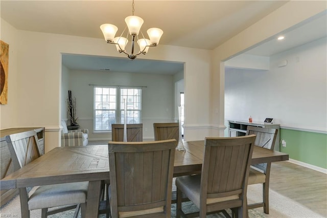 dining room with an inviting chandelier and hardwood / wood-style flooring