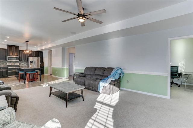 living room with light carpet and ceiling fan