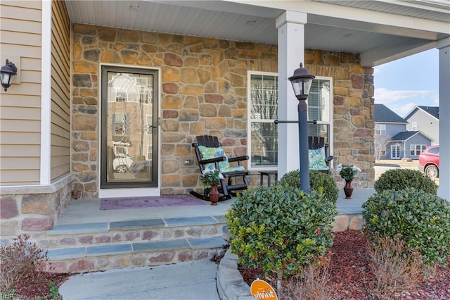 entrance to property featuring a porch