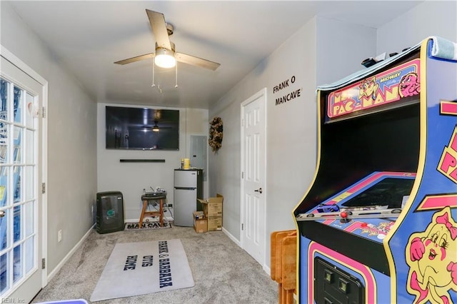 recreation room featuring light colored carpet and ceiling fan