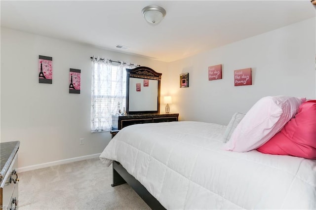 bedroom with light colored carpet