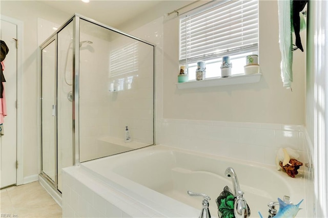 bathroom with tile patterned floors and independent shower and bath