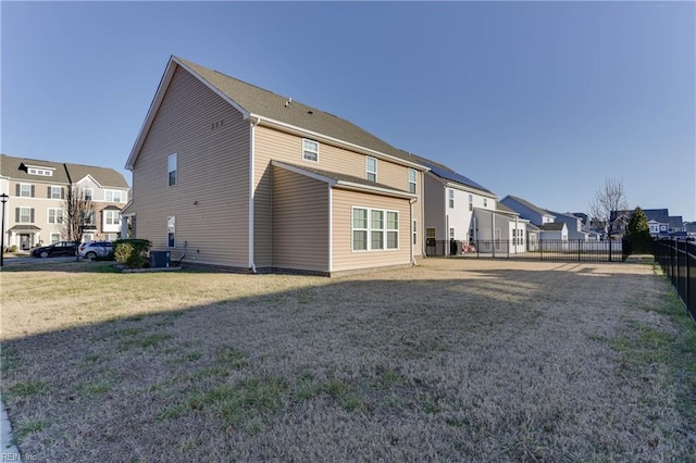 rear view of property featuring a lawn