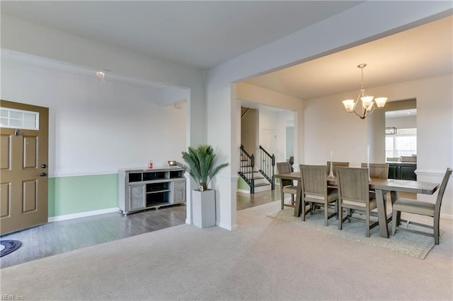 carpeted dining space with a notable chandelier