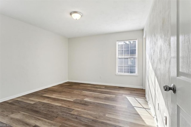 spare room featuring dark hardwood / wood-style flooring