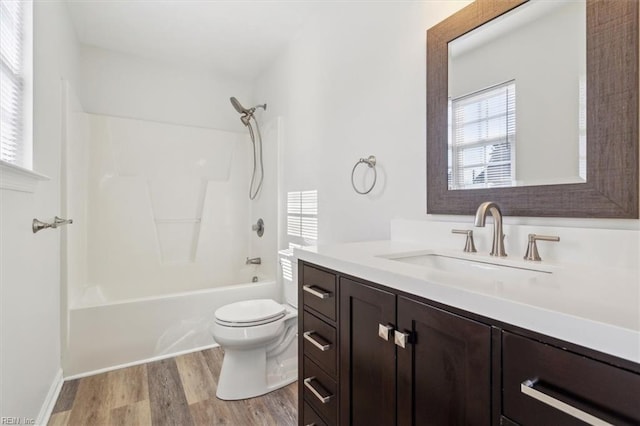 full bathroom featuring hardwood / wood-style flooring, vanity, shower / bathing tub combination, and toilet