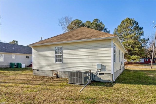 view of side of home with a lawn and central air condition unit