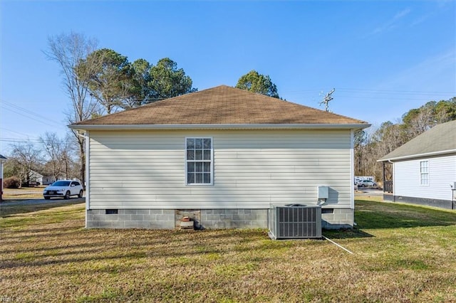 view of side of property featuring cooling unit and a lawn