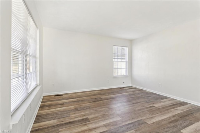 empty room with dark wood-type flooring