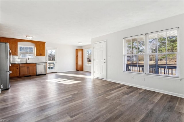 unfurnished living room with dark hardwood / wood-style flooring and sink