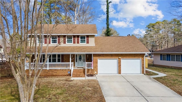 view of front of house with a garage, a porch, and a front yard