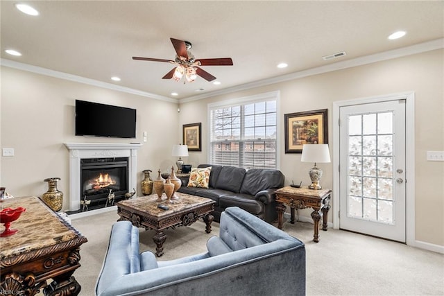 carpeted living room featuring crown molding and ceiling fan