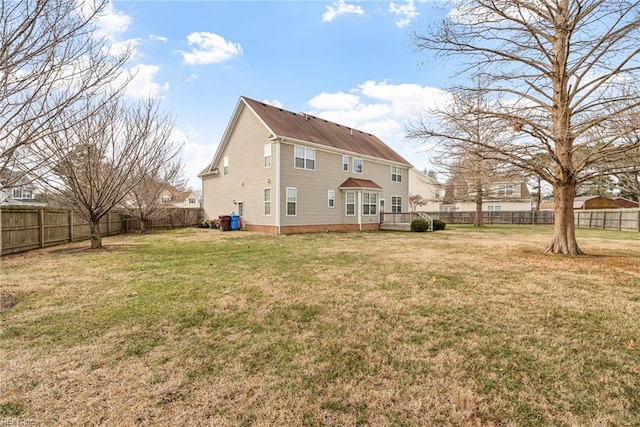 rear view of house with a yard