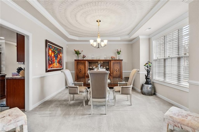 dining area featuring crown molding, light colored carpet, a tray ceiling, and a notable chandelier