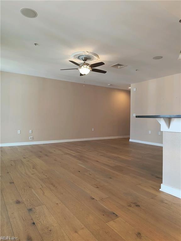 unfurnished room with wood-type flooring and ceiling fan