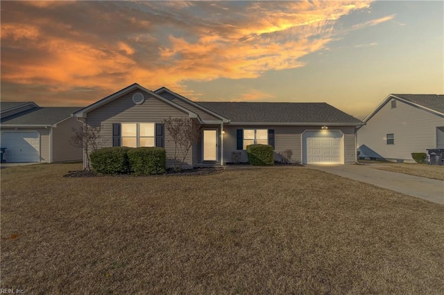 single story home with a garage and a lawn