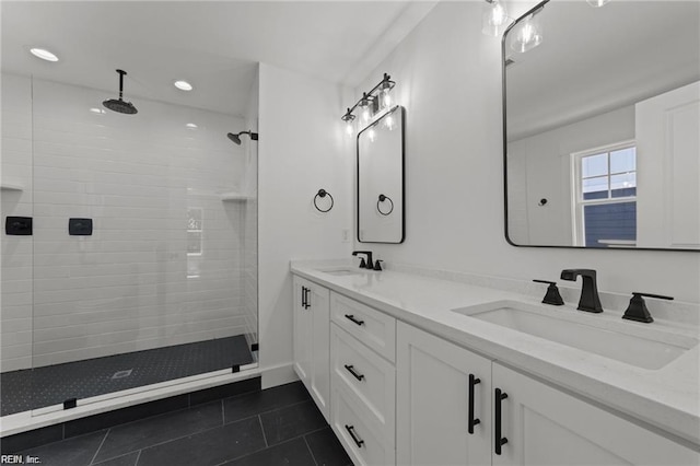 bathroom featuring tiled shower, tile patterned floors, and vanity