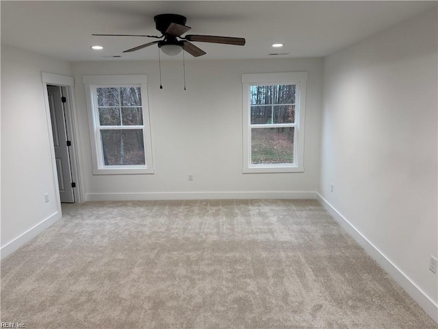 empty room with light colored carpet and ceiling fan